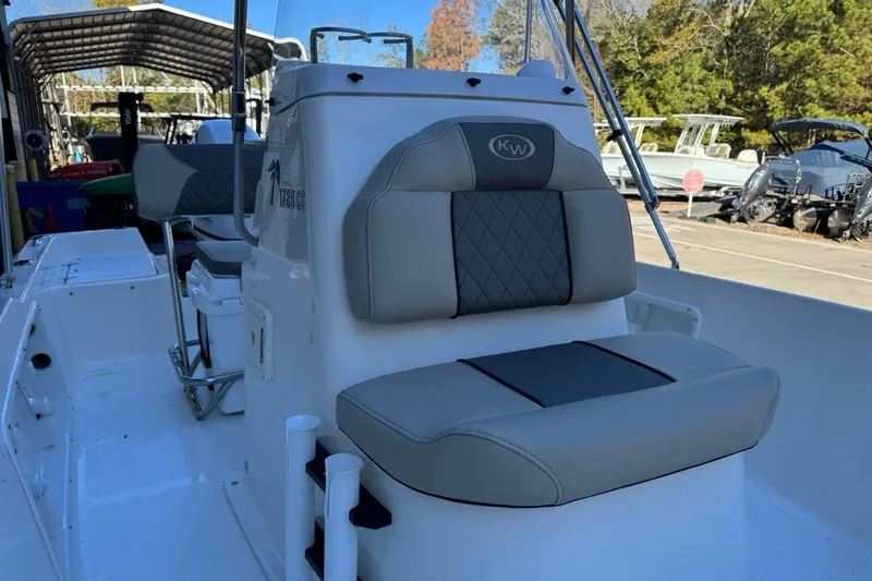 Slide: The Image of 2026 Key West 1720 Center Console boat with cushioned seating, docked outdoors. - 18