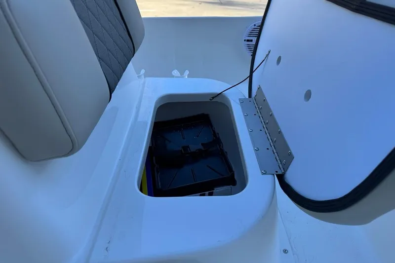 Slide: The Image of 2026 Key West 1720 Center Console boat storage compartment with open lid. - 19
