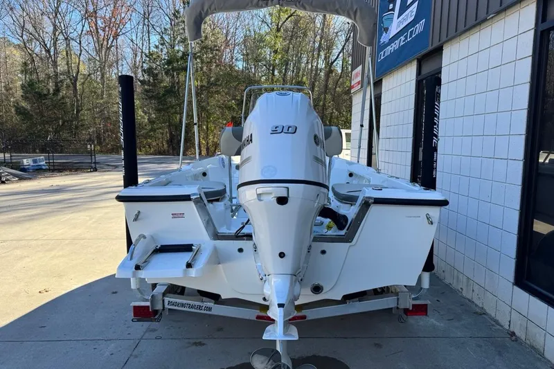 Slide: The Image of 2026 Key West 1720 Center Console boat with Yamaha engine, parked outside a building. - 3