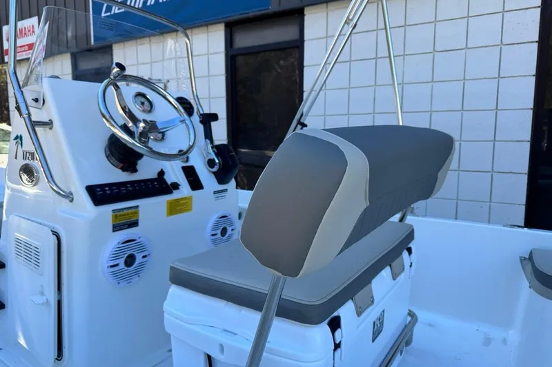 Slide: The Image of 2026 Key West 1720 Center Console boat interior with steering wheel and seating. - 9