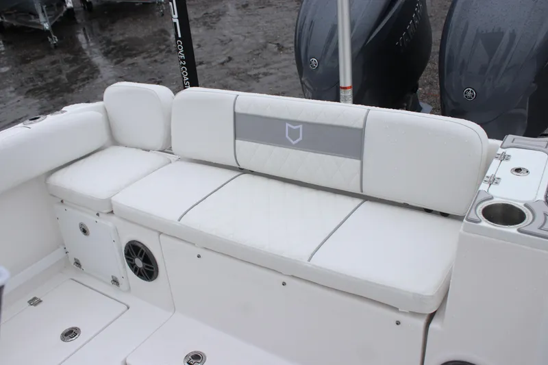 Slide: The Image of 2026 Sea Fox 268 Commander boat interior with white cushioned seating and storage compartments. - 12