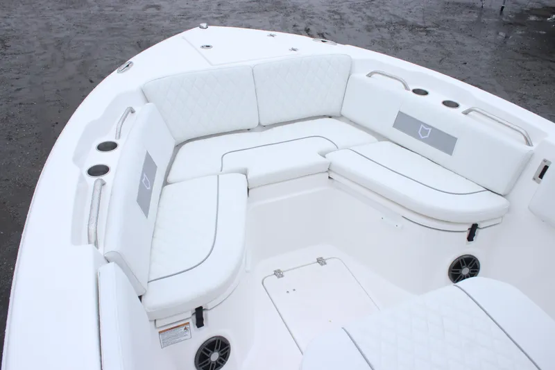 Slide: The Image of 2026 Sea Fox 268 Commander boat with white cushioned seating and cup holders. - 14