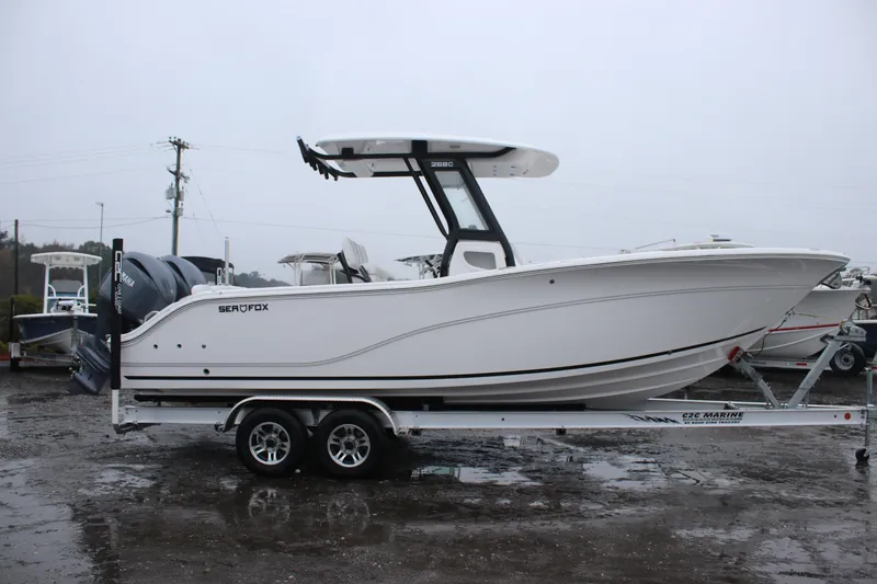Slide: The Image of 2026 Sea Fox 268 Commander boat on trailer, side view, overcast day. - 2