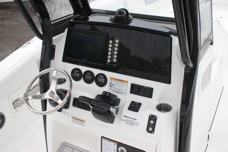 Slide: The Image of 2026 Sea Fox 268 Commander dashboard with steering wheel and navigation controls. - 8