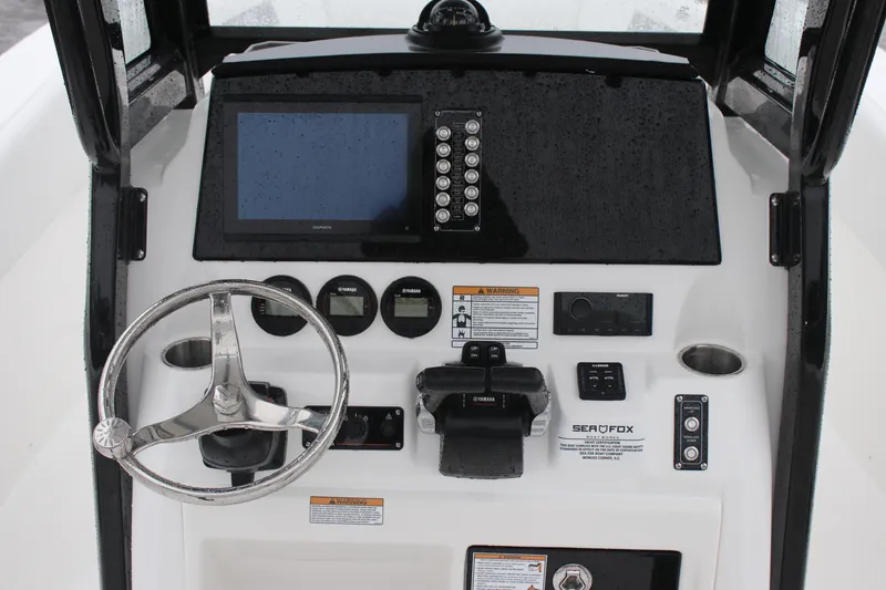 Slide: The Image of 2026 Sea Fox 268 Commander dashboard with steering wheel and electronic controls. - 9