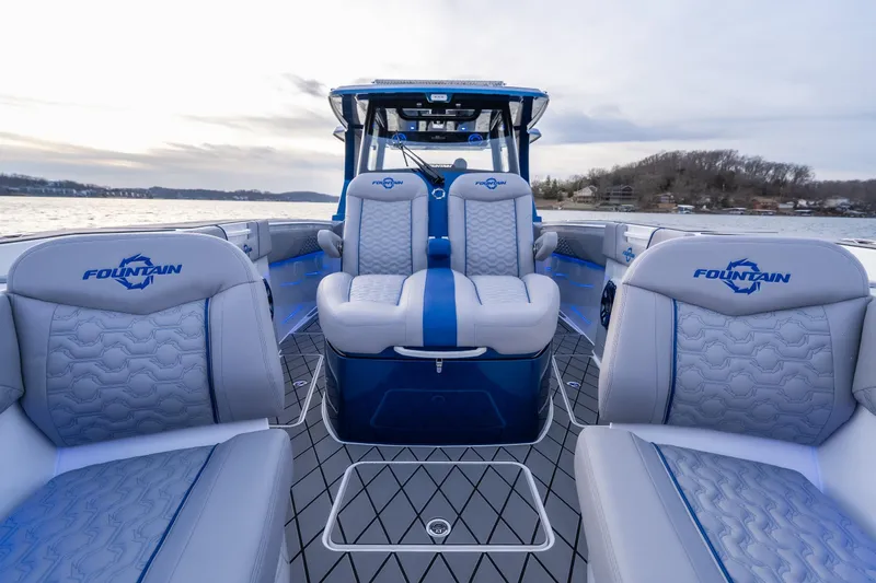 Slide: The Image of 2026 Fountain 38 SCX boat interior with luxurious seating on a serene lake. - 14