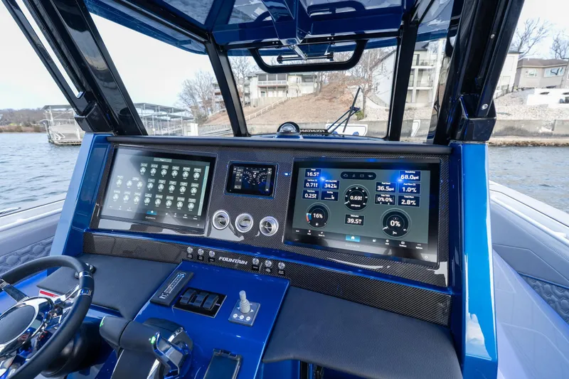 Slide: The Image of 2026 Fountain 38 SCX boat dashboard with advanced digital displays and controls. - 17