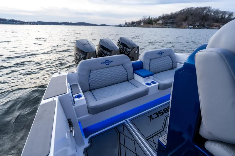 Slide: The Image of 2026 Fountain 38 SCX boat interior with luxurious seating and powerful engines on a serene lake. - 19