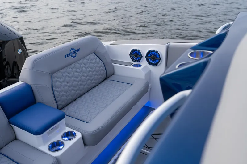 Slide: The Image of 2026 Fountain 38 SCX boat interior with plush seating and blue LED lighting. - 21