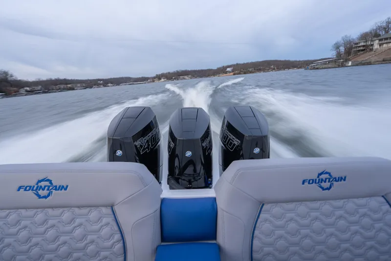 Slide: The Image of 2026 Fountain 38 SCX boat with triple engines speeding on a lake. - 33