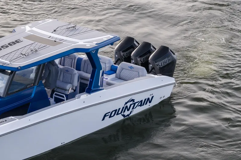 Slide: The Image of 2026 Fountain 38 SCX boat with triple outboard engines on water. - 7