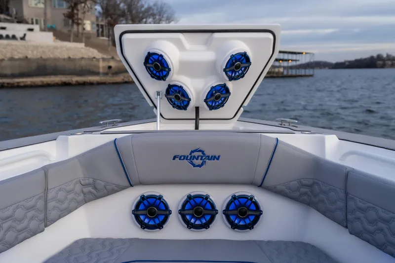 Slide: The Image of 2026 Fountain 38 SCX boat with blue speakers and luxurious seating on the water. - 9