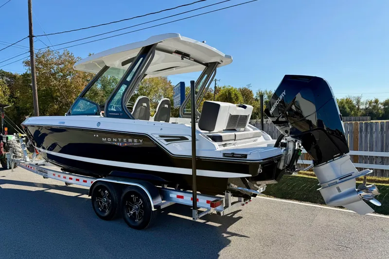 Slide: The Image of 2026 Monterey Elite 27 OB boat on trailer, outdoor setting. - 2