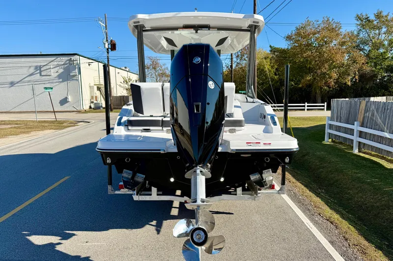 Slide: The Image of 2026 Monterey Elite 27 OB with outboard motor on road. - 3