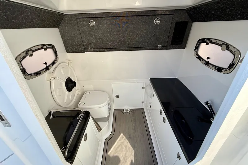 Slide: The Image of Interior of 2026 Monterey Elite 27 OB with toilet and sink. - 19