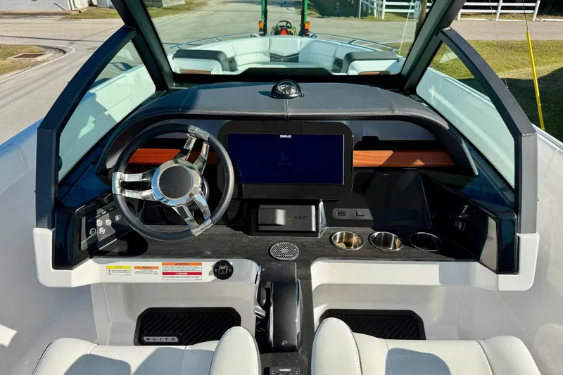 Slide: The Image of 2026 Monterey Elite 27 OB cockpit with modern steering wheel and display. - 14