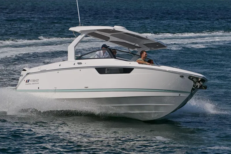 Slide: The Image of Manufacturer Provided Image: 2026 Cobalt R31 OB boat cruising on open water, showcasing sleek design and performance. - 2