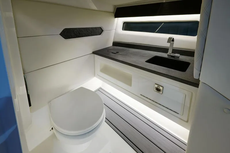 Slide: The Image of Manufacturer Provided Image: 2026 Cobalt R31 OB boat interior with modern sink and toilet. - 9