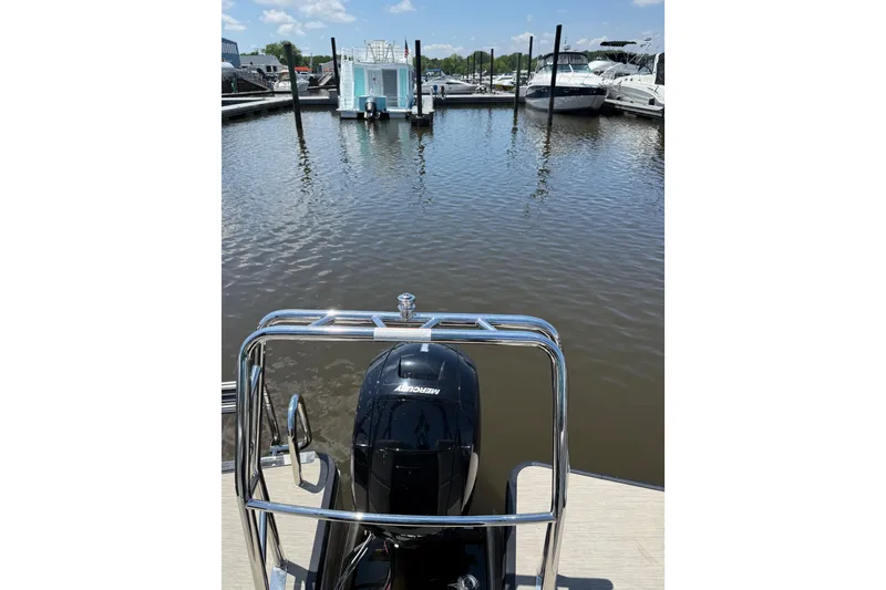 Slide: The Image of 2024 Harris Breeze 230 pontoon boat with Mercury engine at marina dock. - 8
