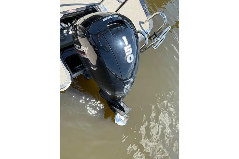Slide: The Image of 2024 Harris Breeze 230 with Mercury 150 outboard motor on water. - 9