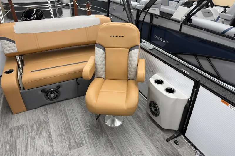Slide: The Image of 2025 Crest Classic 220 boat interior with tan seating and modern design features. - 10