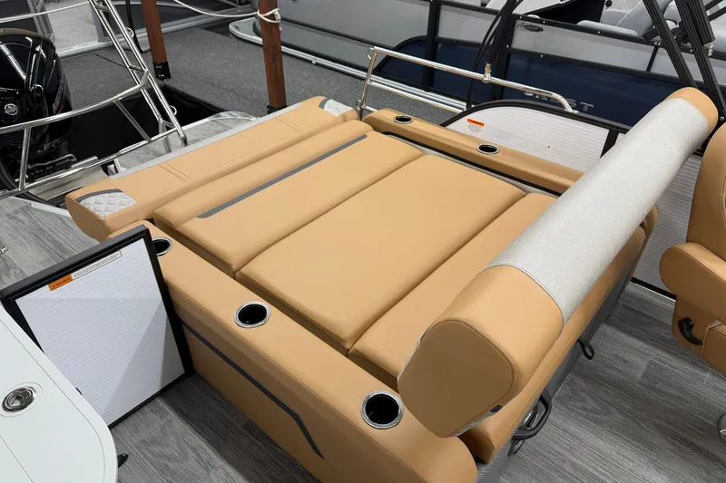 Slide: The Image of 2025 Crest Classic 220 boat interior with tan seating and cup holders. - 11