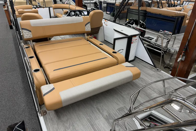Slide: The Image of 2025 Crest Classic 220 pontoon boat with tan seating and modern interior design. - 12