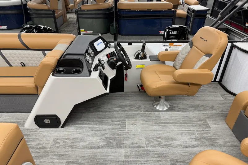 Slide: The Image of 2025 Crest Classic 220 boat interior with tan seating and modern dashboard. - 5