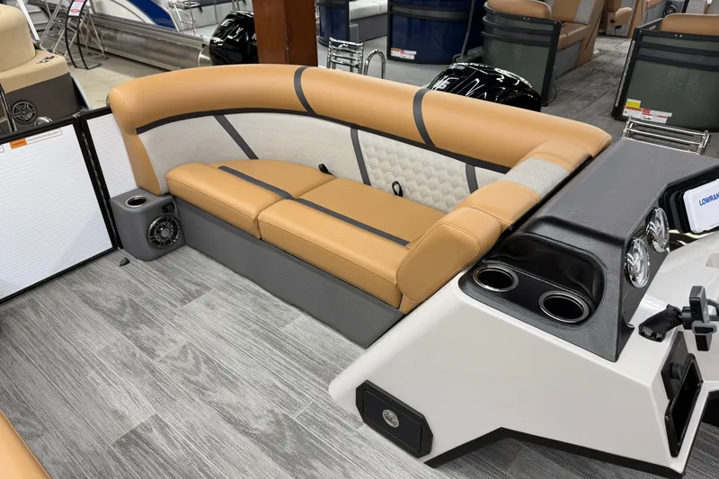 Slide: The Image of 2025 Crest Classic 220 boat interior with tan seating and modern dashboard. - 9