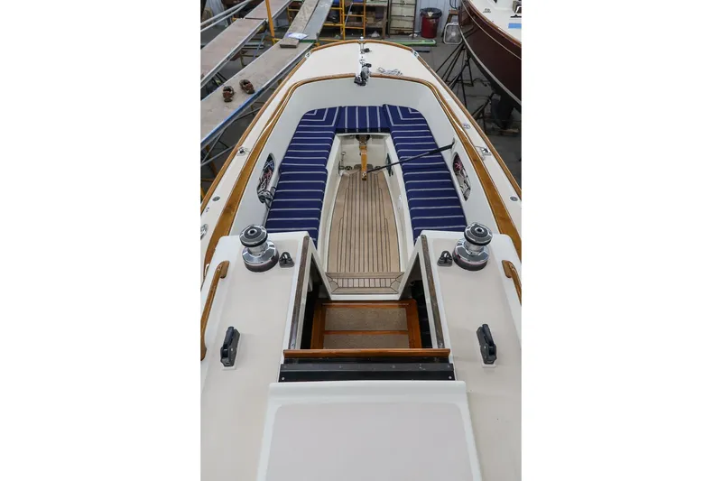 Slide: The Image of 2011 Morris M29 sailboat interior with striped seating and wooden accents. - 13