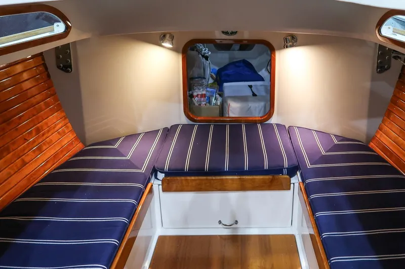 Slide: The Image of Cozy cabin interior of 2011 Morris M29 with striped cushions and wooden accents. - 18