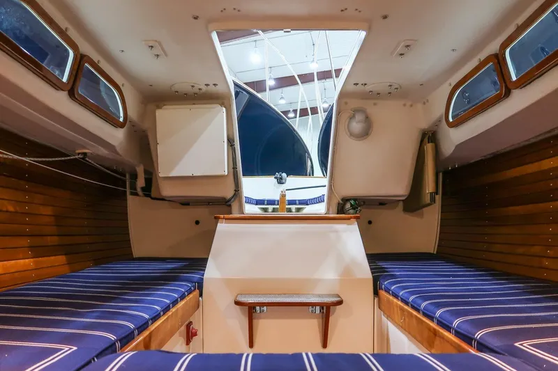 Slide: The Image of Interior of a 2011 Morris M29 sailboat with striped seating and wooden accents. - 19