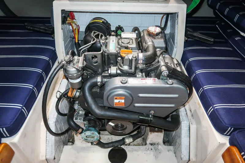 Slide: The Image of Morris M29 engine from 2011, installed in a boat with blue-striped seating. - 22