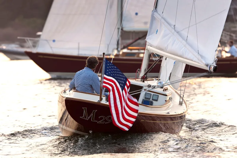 Slide: The Image of Sailboat Morris M29 (2011) with American flag on water at sunset. - 25