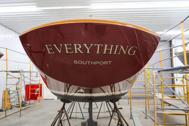 Slide: The Image of Rear view of a 2011 Morris M29 boat named "Everything" in a workshop. - 3