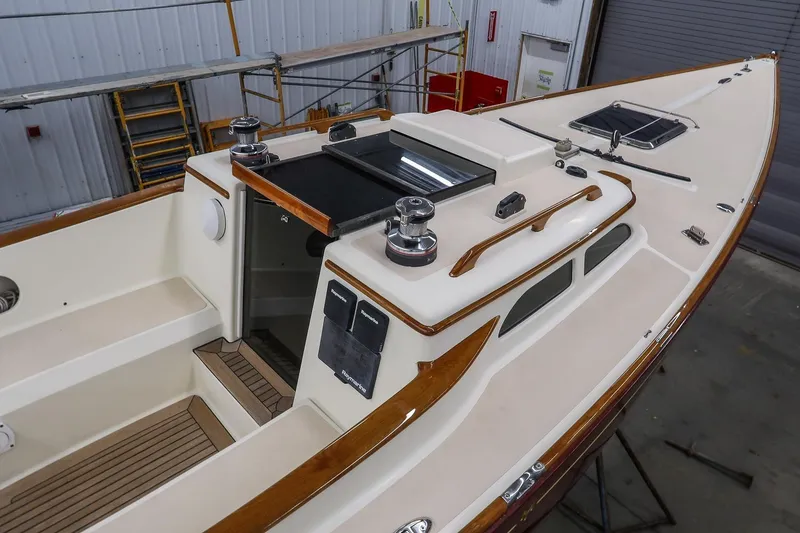 Slide: The Image of 2011 Morris M29 sailboat interior with wooden accents and modern fittings in a workshop. - 7