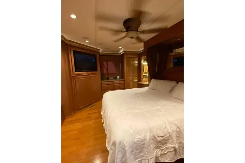 Slide: The Image of Cozy bedroom interior of 2007 Summerset 21' x 106' houseboat with elevated bed and steps. - 106