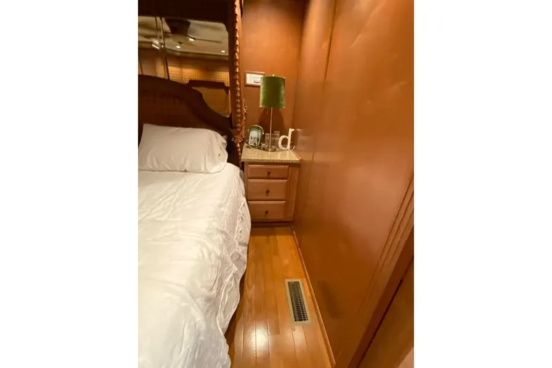 Slide: The Image of Cozy bedroom interior in 2007 Summerset houseboat, featuring a comfortable bed and wooden cabinetry. - 108