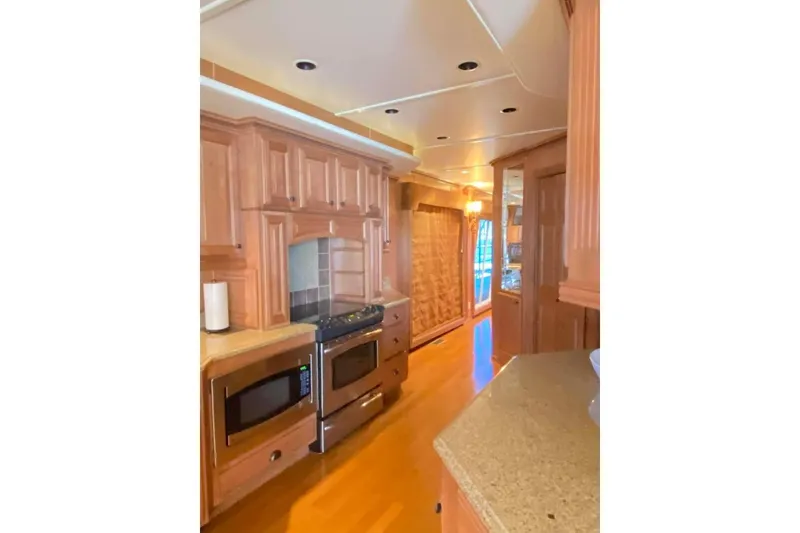Slide: The Image of Luxurious bedroom interior in 2007 Summerset 21' x 106' houseboat with wood accents and ceiling fan. - 109