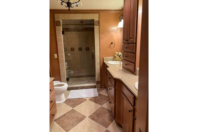 Slide: The Image of Luxurious bedroom interior in 2007 Summerset houseboat, featuring elegant wood furnishings and cozy bedding. - 11