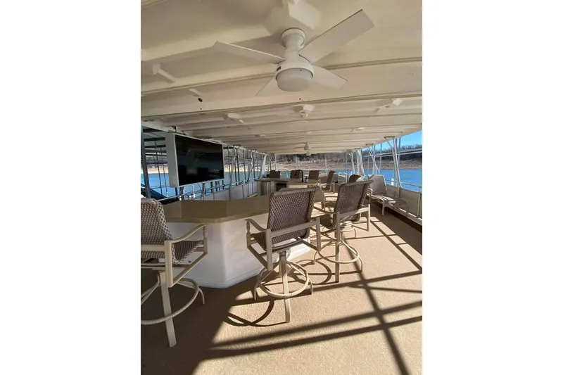 Slide: The Image of Outdoor seating area on a 2007 Summerset 21' x 106' houseboat by the water. - 118