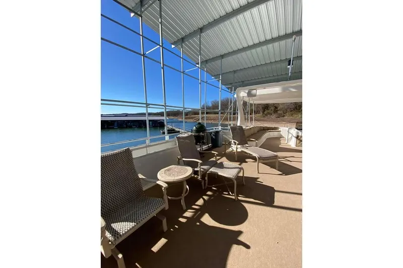 Slide: The Image of Outdoor deck of 2007 Summerset houseboat with lounge chairs and grill, overlooking water. - 128
