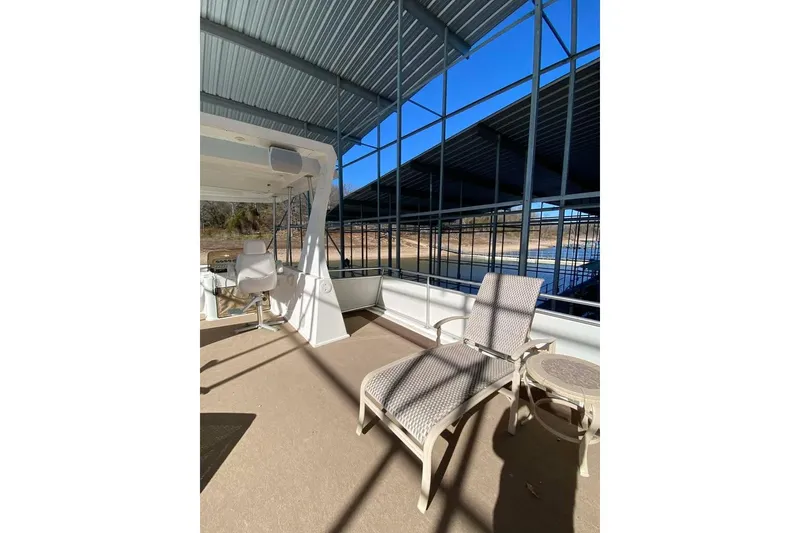 Slide: The Image of Outdoor deck of 2007 Summerset houseboat with lounge chairs under a covered dock. - 130