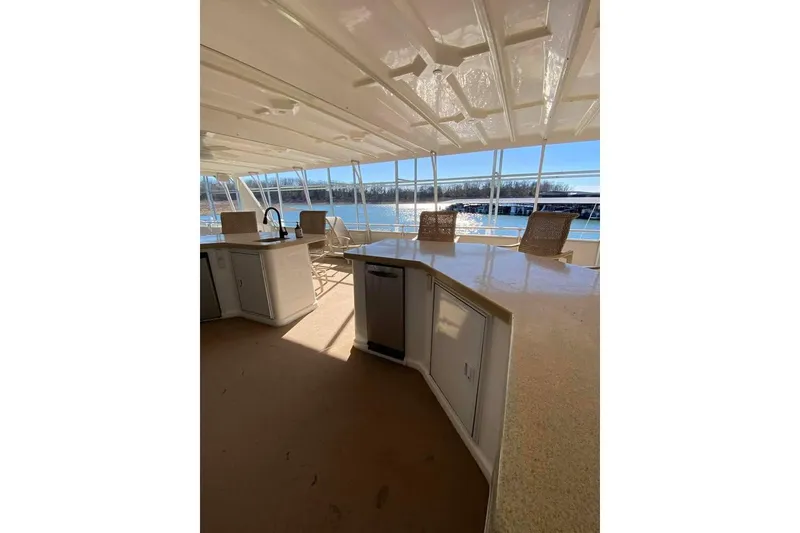 Slide: The Image of Helm of 2007 Summerset 21' x 106' houseboat with seating and steering wheel. - 135