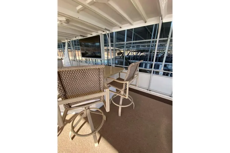 Slide: The Image of Interior of 2007 Summerset houseboat, featuring a spacious deck with a large TV and seating area. - 145