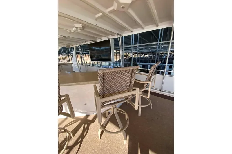Slide: The Image of Luxurious Summerset 21' x 106' houseboat deck with seating, overlooking serene water, 2007 model. - 149