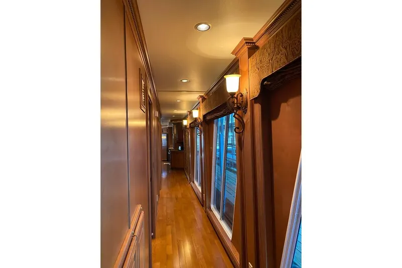 Slide: The Image of Luxurious bedroom interior in 2007 Summerset houseboat, featuring wood paneling and cozy seating area. - 15