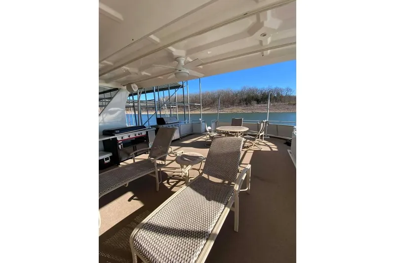 Slide: The Image of Luxurious Summerset 21' x 106' 2007 houseboat interior with bar and wicker chairs. - 150
