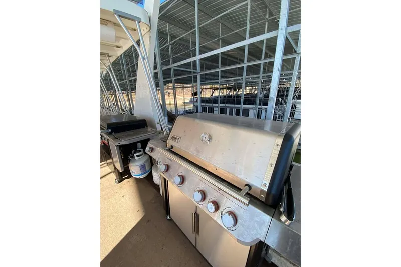 Slide: The Image of Spacious deck of 2007 Summerset houseboat with outdoor seating and grill, overlooking serene water. - 153