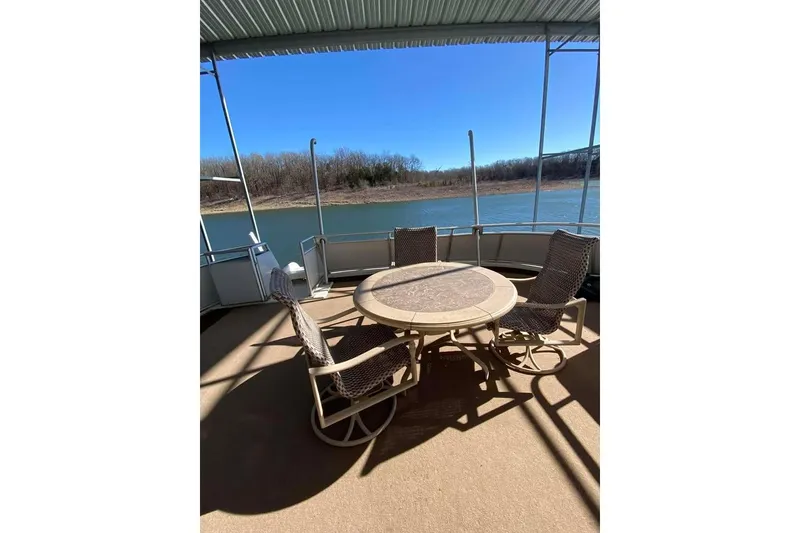 Slide: The Image of Summerset 21' x 106' 2007 boat deck overlooking serene lake and wooded shoreline. - 155